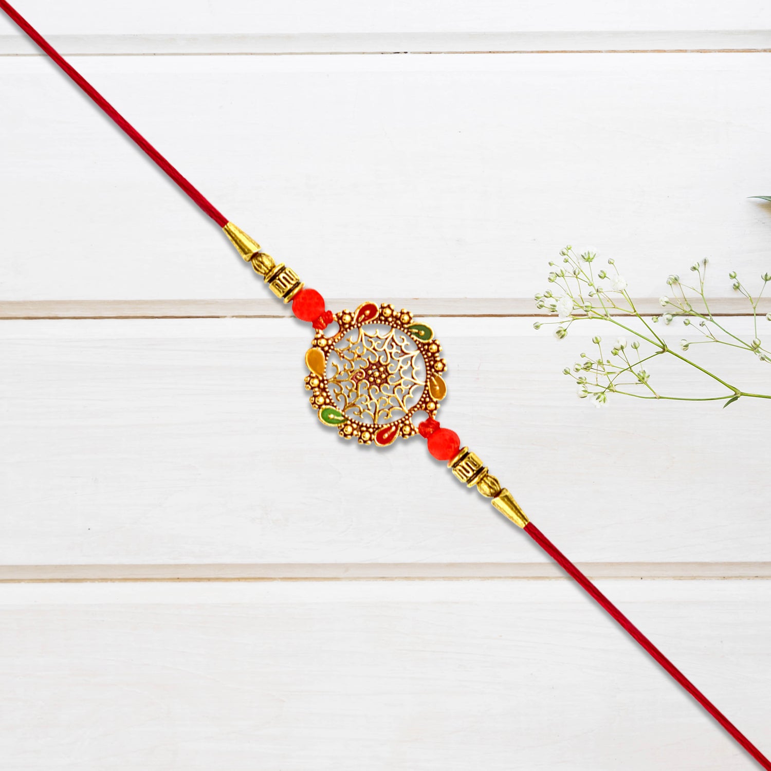 Intricately Designed Circular Rakhi With Multicolor Accents And Red Thread For Rakshabandhan - warehousetech13