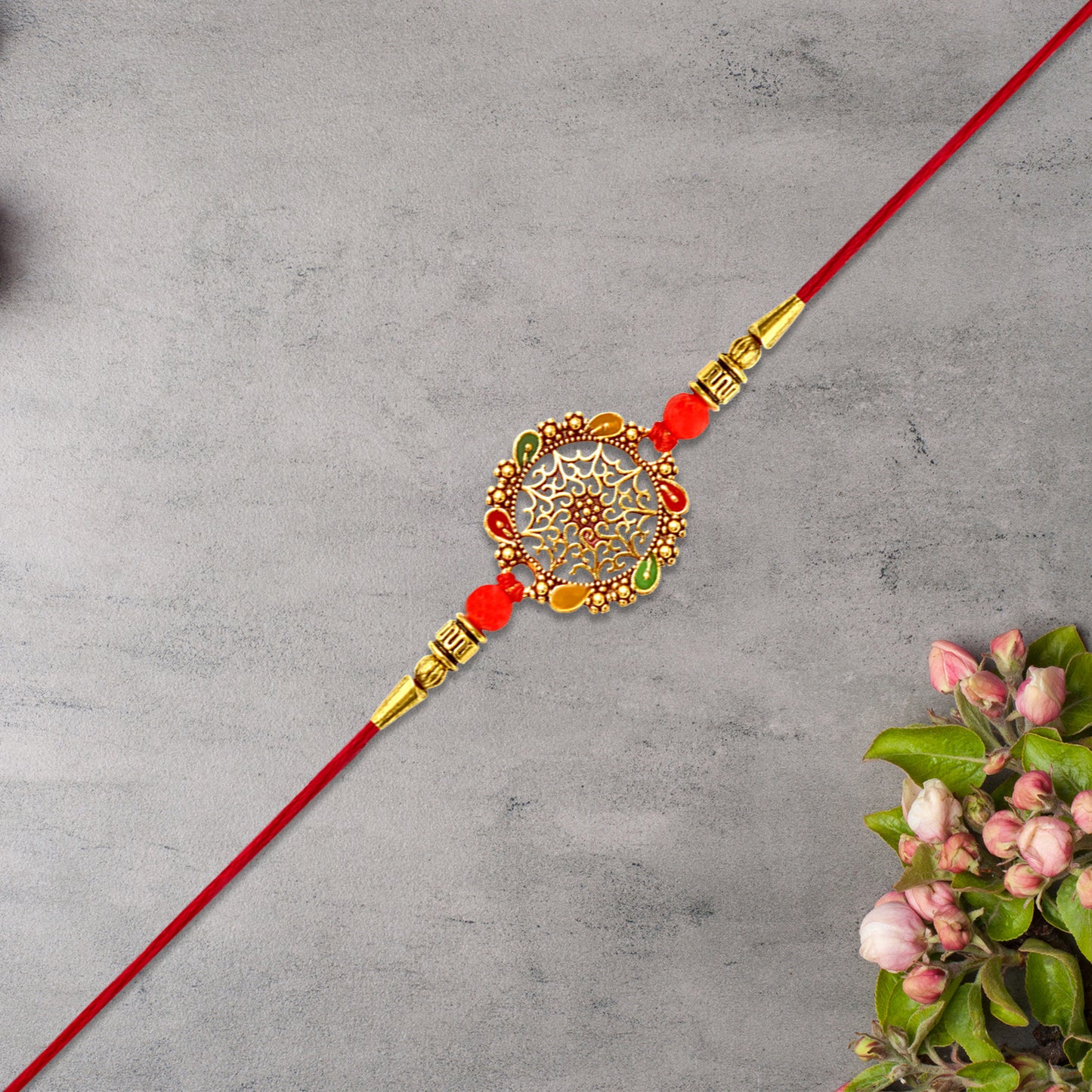Intricately Designed Circular Rakhi With Multicolor Accents And Red Thread For Rakshabandhan - warehousetech13