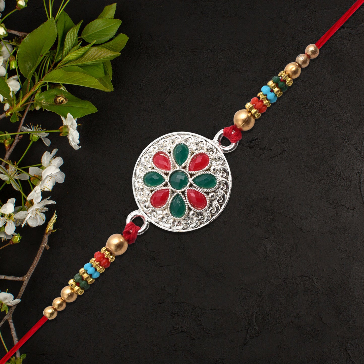 Silver Plated Floral Rakhi With Red Green Stones - warehousetech13