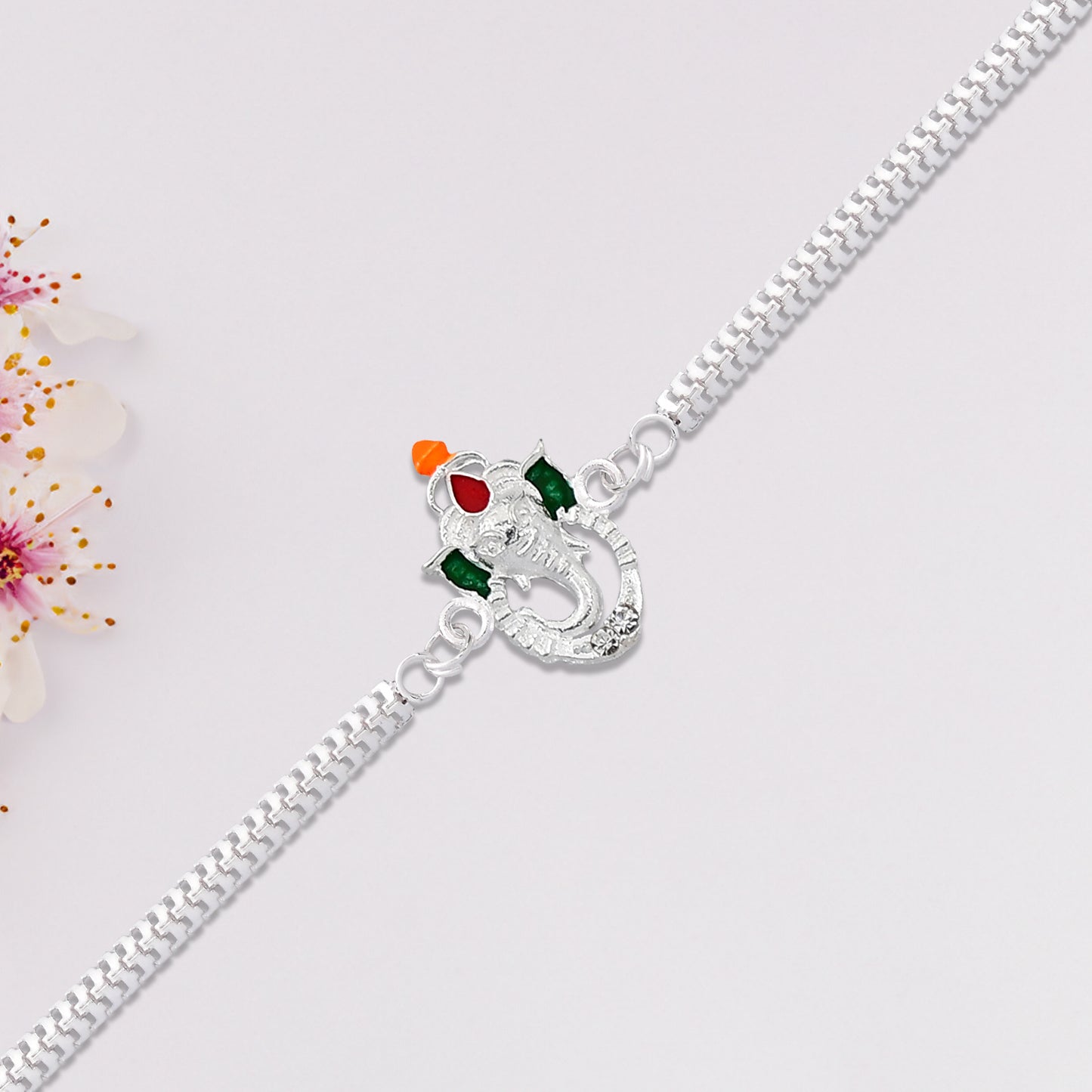 Stylish Ganesha Rakhi With Enamel Highlights And Silver Metal Chain - warehousetech13