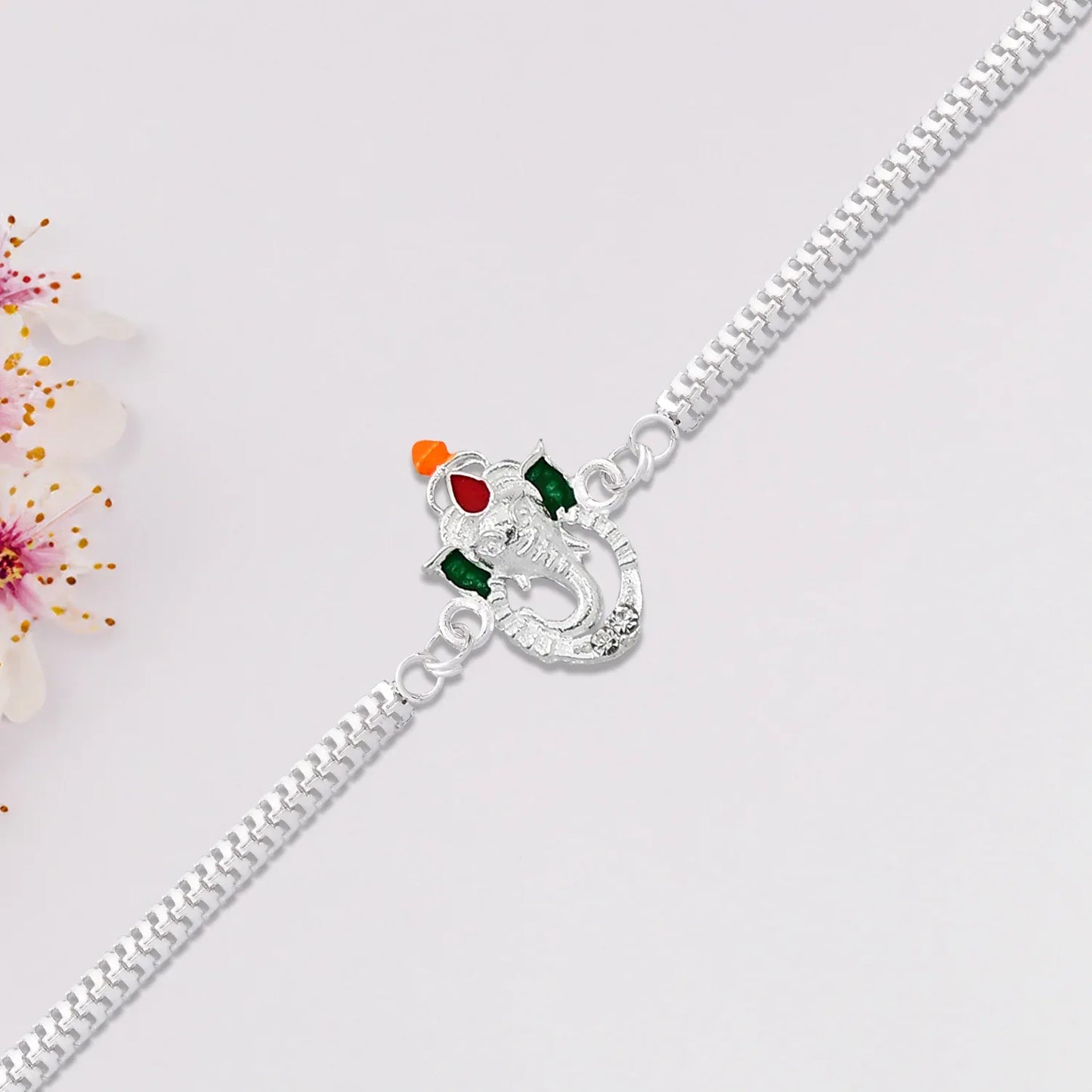 Stylish Ganesha Rakhi With Enamel Highlights And Silver Metal Chain - warehousetech13