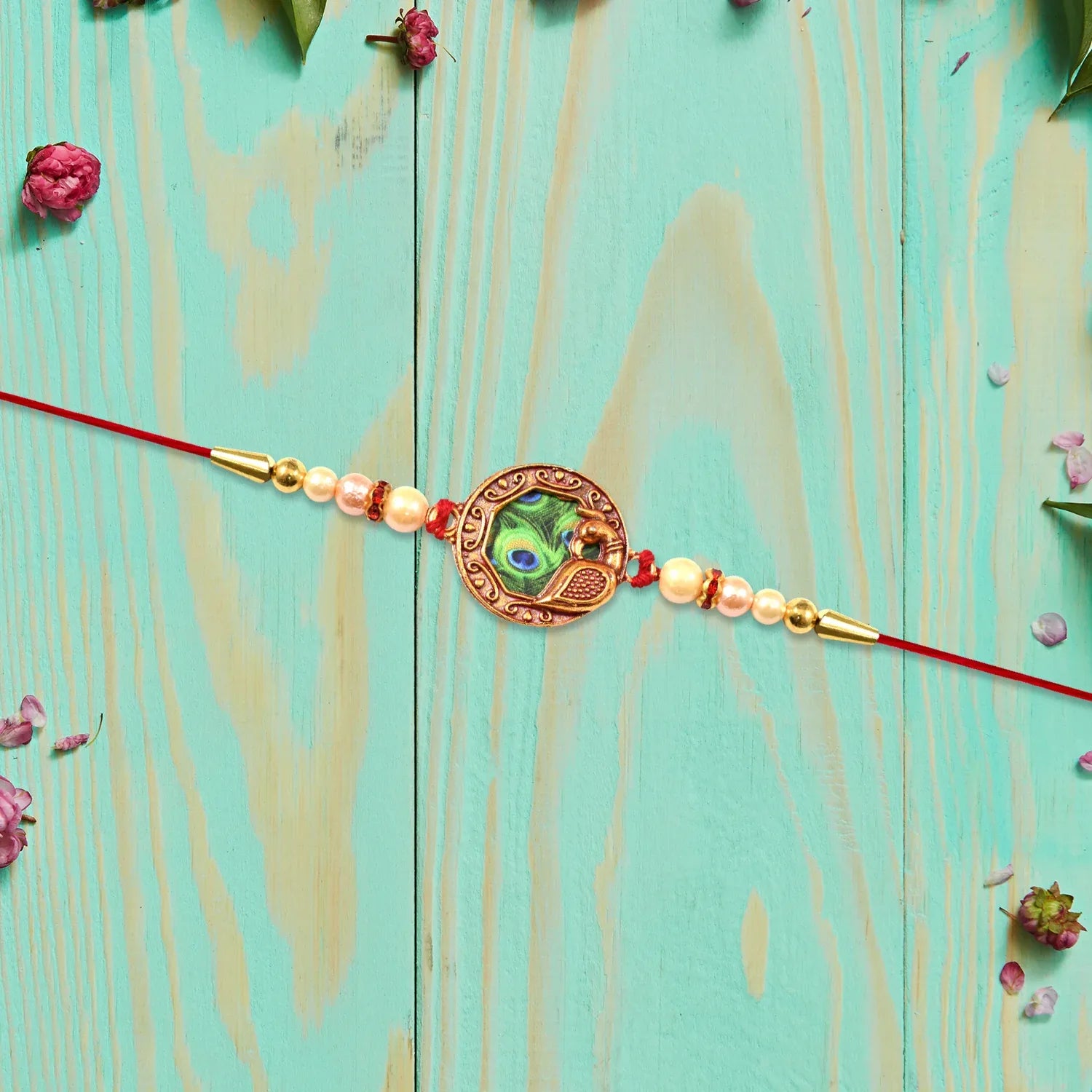 Elegant Rakhi With Peacock Feather Design And Pearl Bead Accents On Red Thread - warehousetech13
