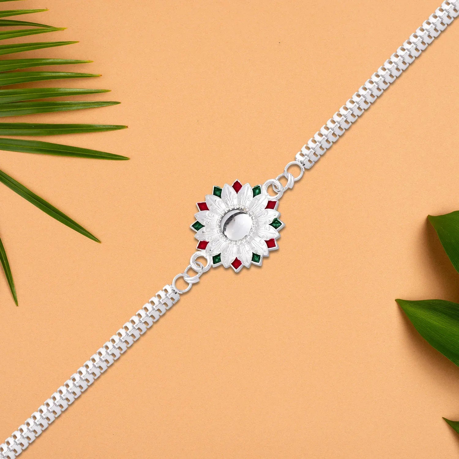 Elegant Silver-plated Floral Rakhi With Red And Green Meenakari Accents - warehousetech13