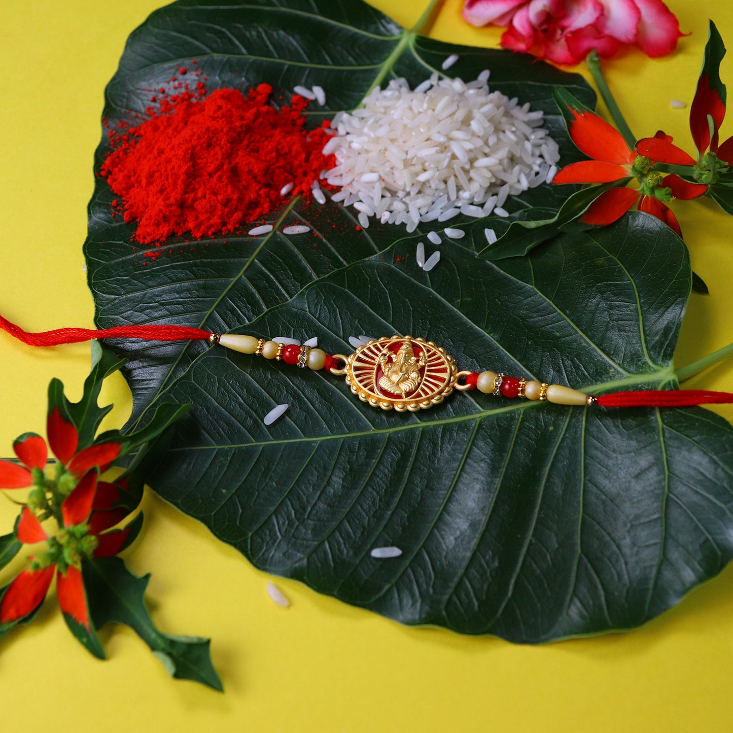 Traditional Ganesha Rakhi With Golden Finish And Sacred Red Thread - warehousetech13