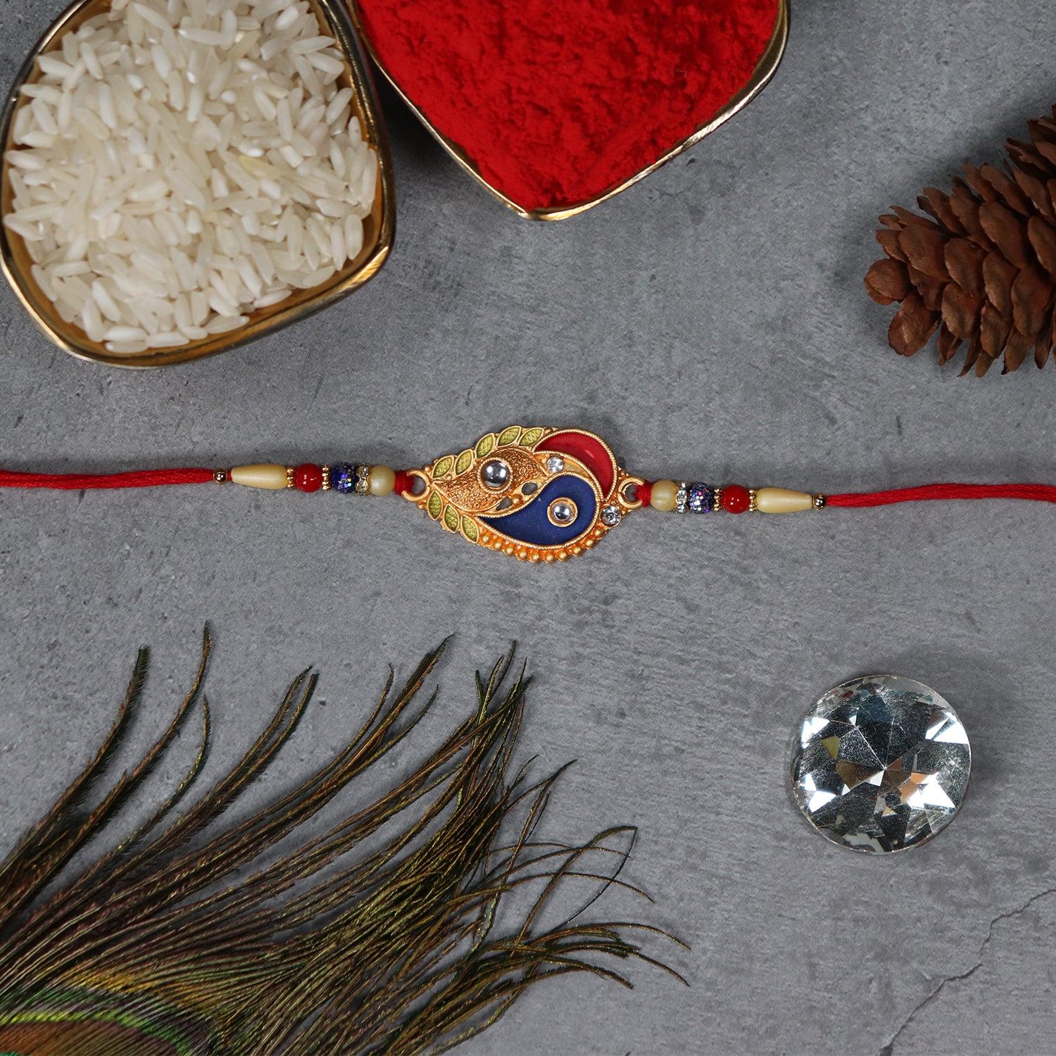 Elegant Rakhi With Enamel Paisley Design And Gold-tone Embellishments - warehousetech13
