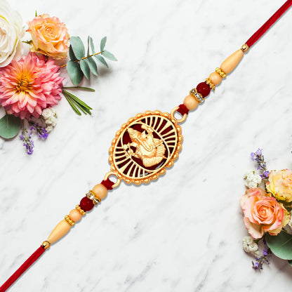 Traditional Ganesha Rakhi With Golden Finish And Sacred Red Thread - warehousetech13