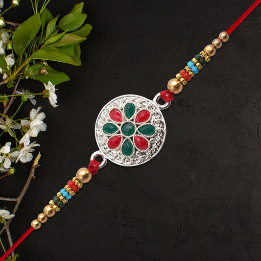 Silver Plated Floral Rakhi With Red Green Stones - warehousetech13